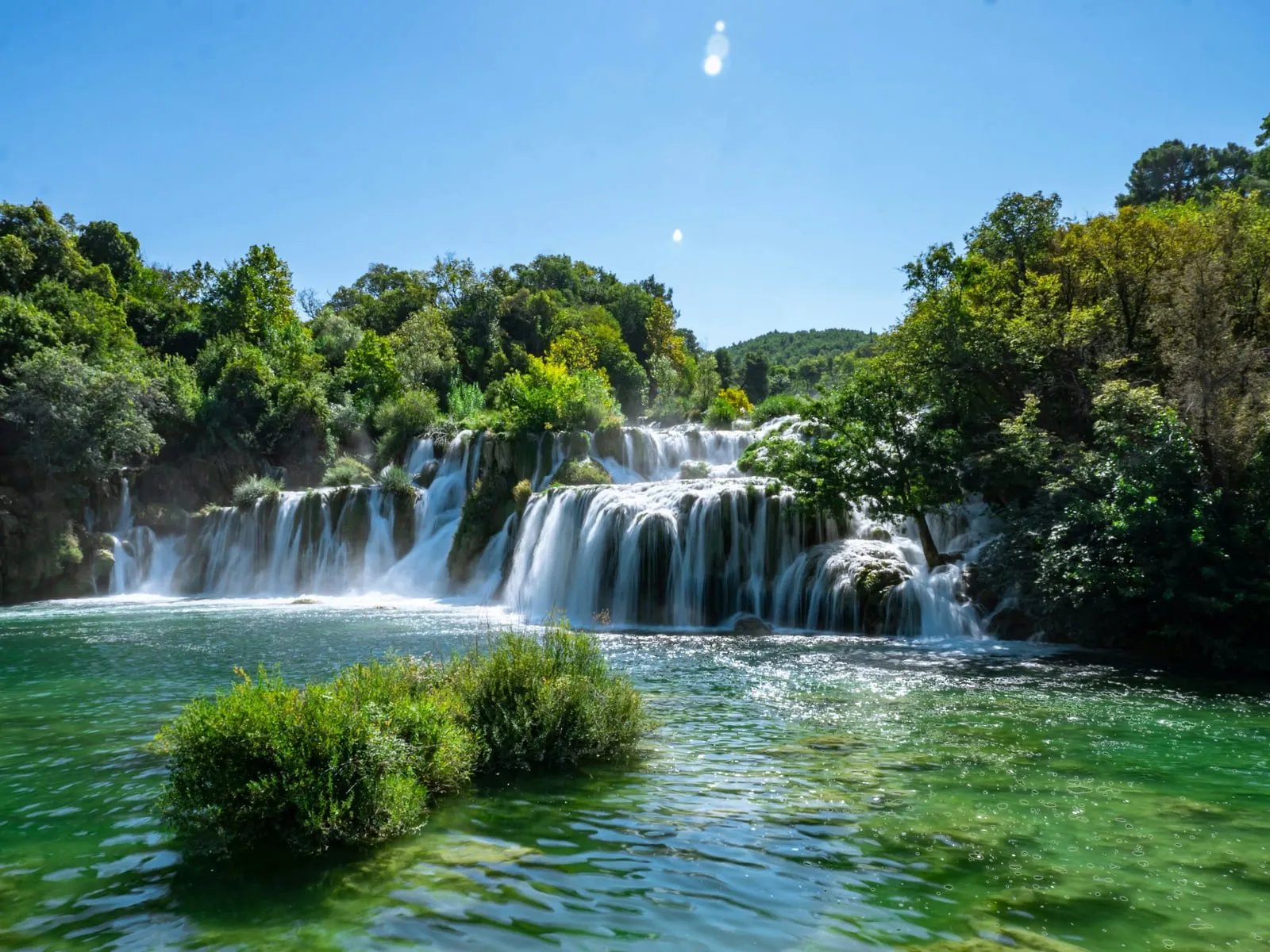 a large waterfall in the middle of a river