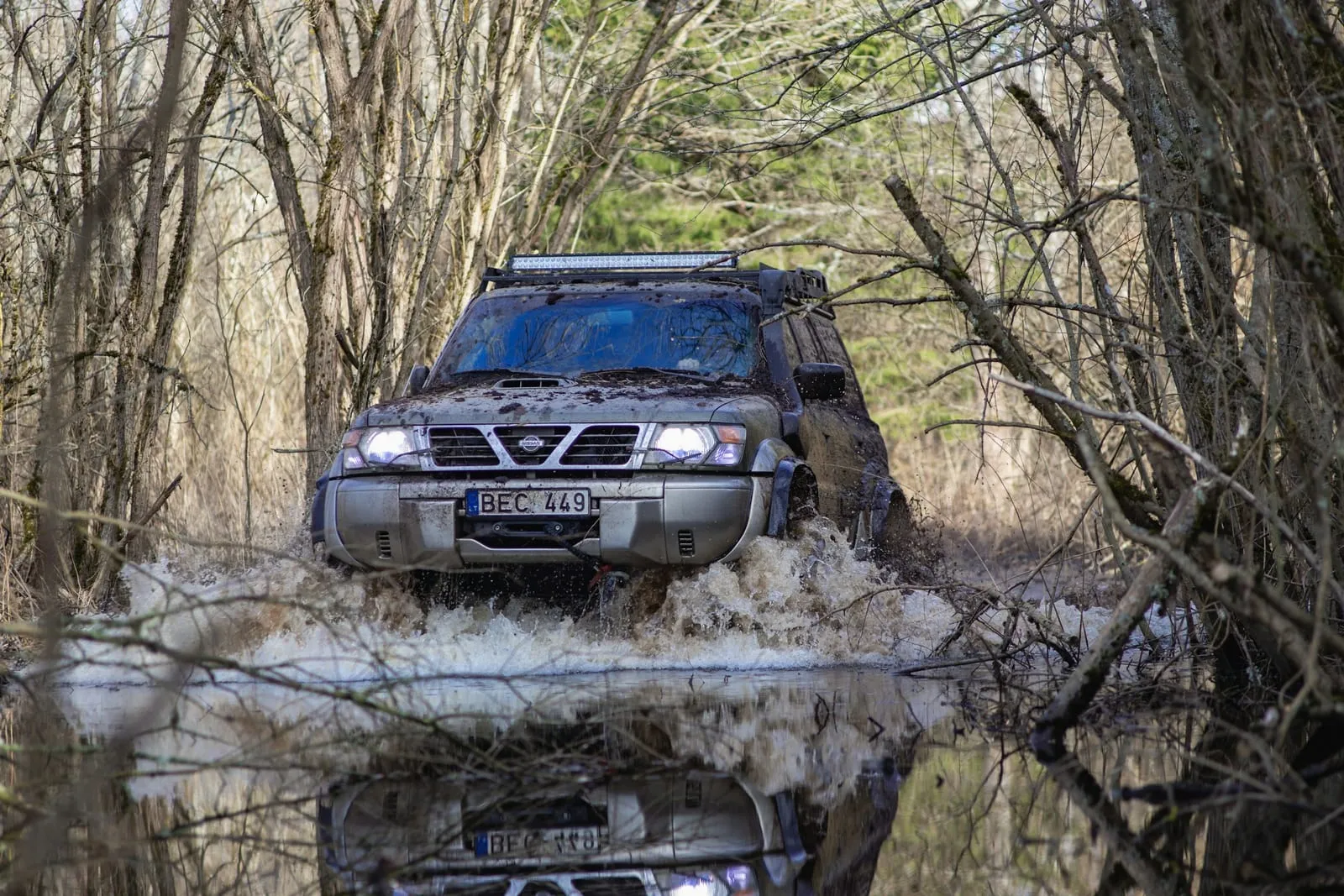 a truck driving through a puddle of water