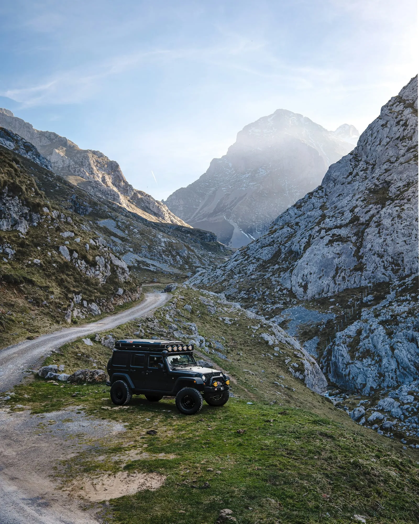 Off-road vehicle parked in a mountainous landscape.