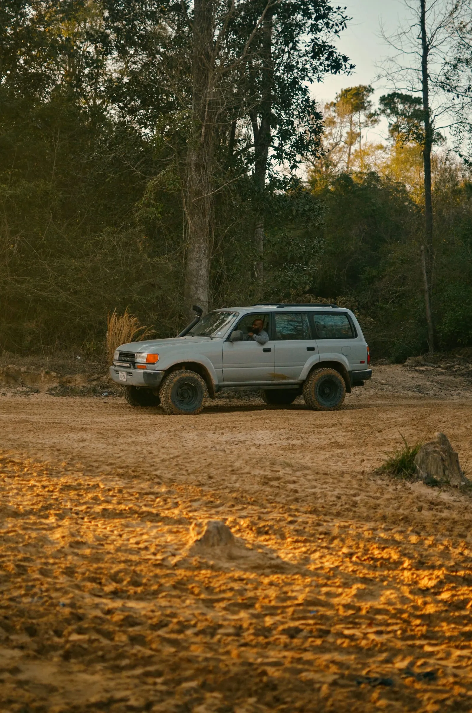 white suv on dirt road